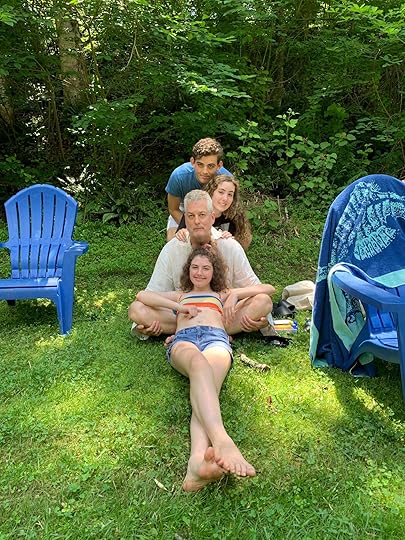 Image may contain: 4 people, including Jack Dougherty, people sitting, tree, grass, child, outdoor and nature