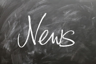 blackboard with news written on it