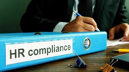 desk image showing a binder with HR Compliance as the title