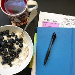 yogurt and berries tea and planner and pen