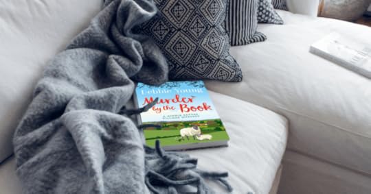 image of murder by the book on a sofa with blankets