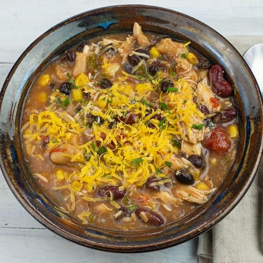 chicken chili topped with cheese in a bowl.