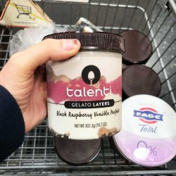 woman holding carton of talent in store