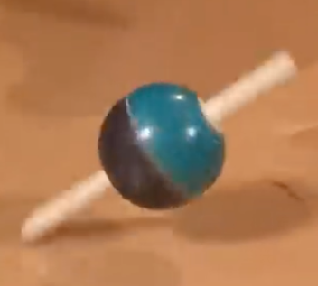Figure 2. A spinning top at an angle from a YouTube video:  https://youtu.be/lWTnOrqqYU0?t=167 .