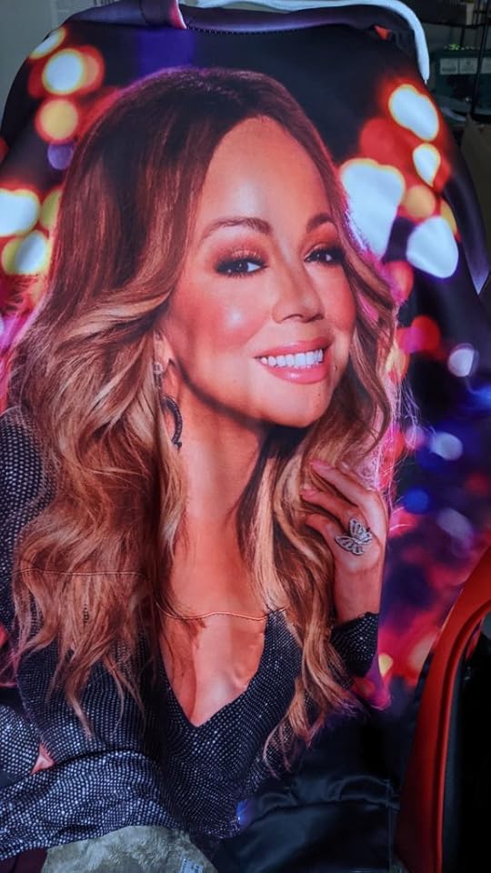 A hoodie draped over the back of my computer chair. It is printed with a huge image of Mariah Carey. As in, like a photo of Mariah Carey is the print of the entire fabric.