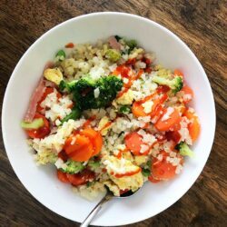 bowl of cauliflower fried rice with sriracha