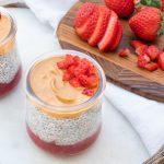 Two Jars of PB&J Chia Parfait with Sliced Strawberries on a White Towel