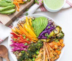 Bowl of colorful veggies with a small bowl of green tahini dressing