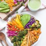Bowl of colorful veggies with a small bowl of green tahini dressing