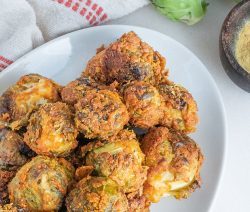 Nutritional Yeast & Tahini Coated Brussles Sprouts Served on a White Platter