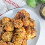 Nutritional Yeast & Tahini Coated Brussles Sprouts Served on a White Platter