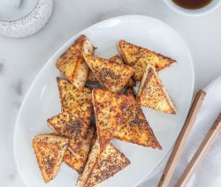 Sweet & Salty Tofu Triangles Served in a Dish with Soy Sauce and Chopsticks