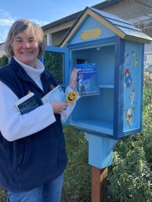Michelle Ule holds a copy of A Poppy in Remembranvce