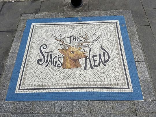 Victorian Advertising, on the sidewalk, inviting passersby to enter an alley to find The Stag's Head.