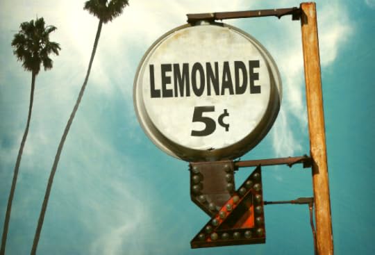 Retro lemonade 5c sign against sky with palm trees