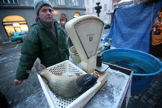 Vendor weighing a carp
