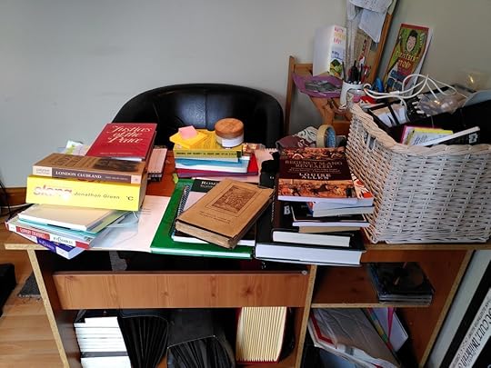 Desk absolutely covered in books and crap