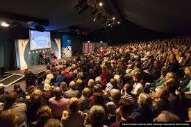 A large crowd of people in a roomDescription automatically generated with medium confidence