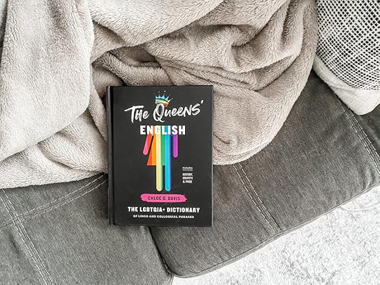 A photo of The Queens English on a gray couch.