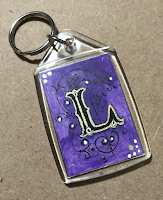 Keyring with a tiny illuminated letter, artist Linzé Brandon