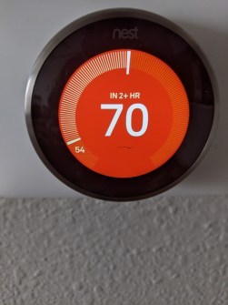 A thermostat reading 54 degrees