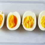 sliced hard and soft cooked eggs on board