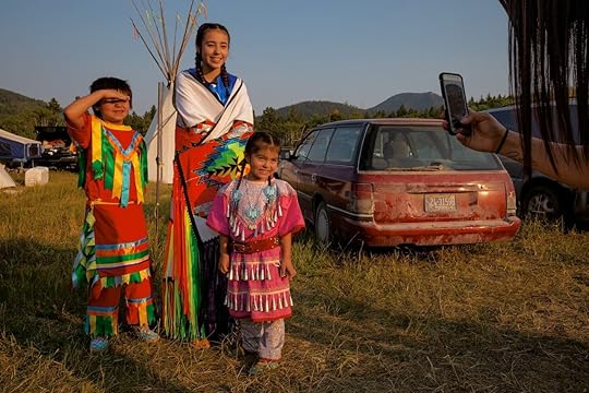 three children posing for a picture in bright colored attire