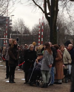 A man in a wheelchair preparing to lay flowers