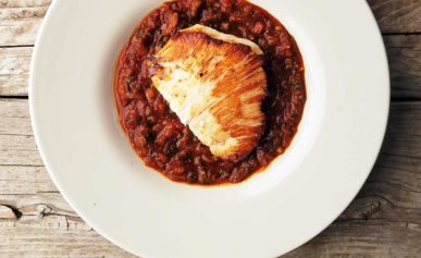 Halibut cheeks with saffron tomato sauce in a bowl