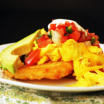 side view of hash brown breakfast stacks with scrambled eggs.
