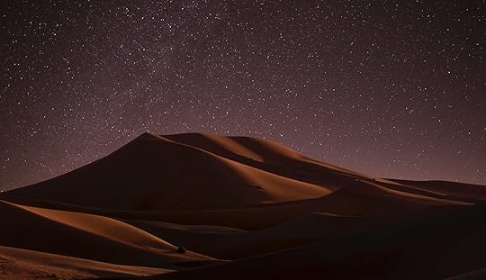 A sand dune at night.