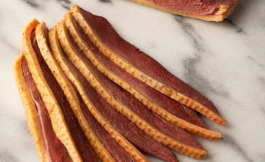 Slice of duck bacon on a marble board