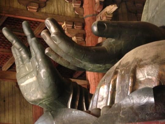 Image: hands of a large Buddha statue