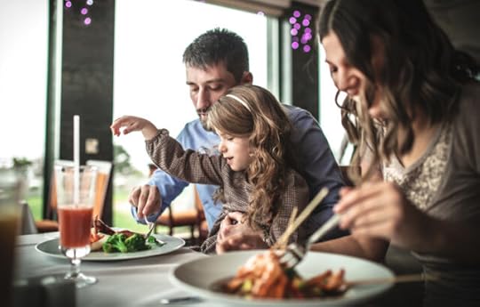 man and woman eating keto at a restaurant with their young daughter
