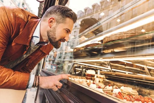 man choosing from a bakery case