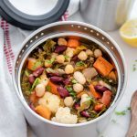 Insulated container filled with a hearty kale and bean soup
