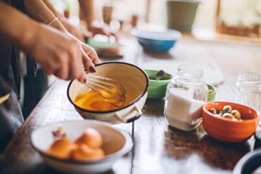 woman whisking egg yolks to thicken sauce