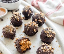 Chocolate Covered Balls with nuts on top on a oval serving plate