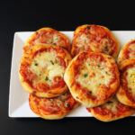 rectangular plate of mini pizzas