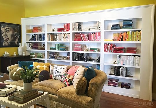 DIY built-in bookshelves with a hidden bookcase door and color blocked book styling. A fun way to add character and book storage to a room!