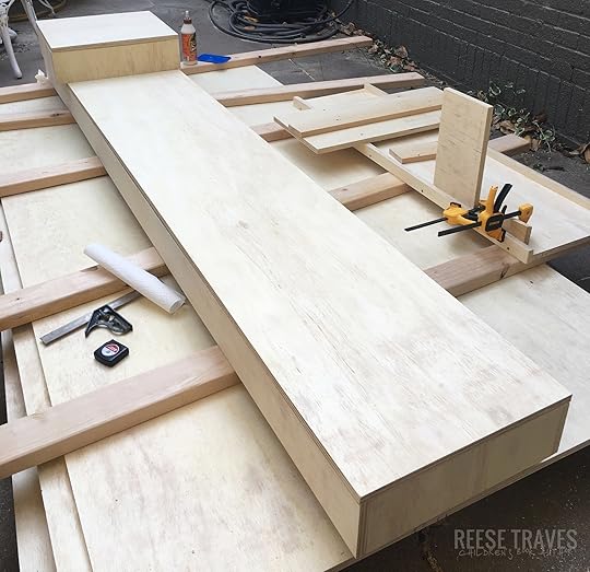 Base made out of plywood to hold semi-permanent built-in bookshelves...that could technically be removed since they are on top of the original floor.