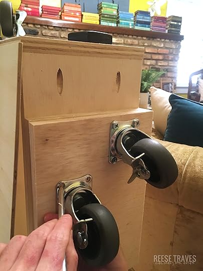 Casters on the bottom of hidden bookcase door.