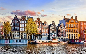 Amsterdam-Netherlands-dancing-houses-over-river-Amstel-landmark-in-old-european-city-spring-landscap