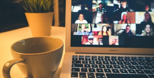 Laptop screen showing remote team members on a video call