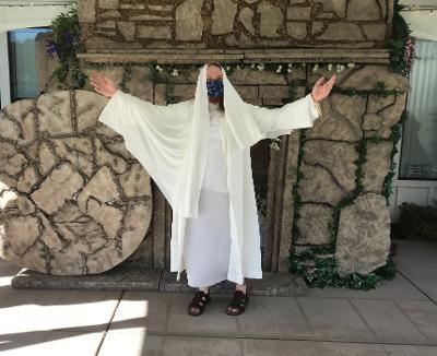 A Holy Week walk includes Jesus risen from the tomb