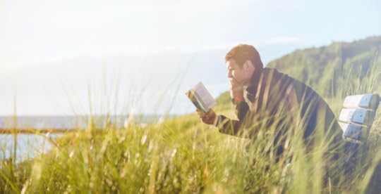 Man reading and relaxing outdoors
