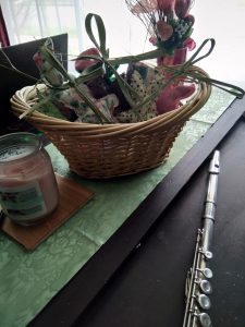 spring brings new hope, basket of rustic bunnies, carrots, eggs, palm crosses, candle, flute