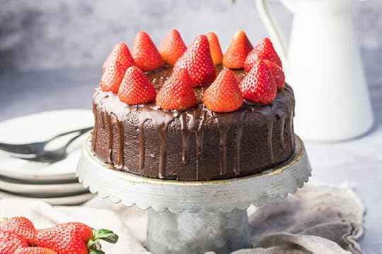 gluten-free chocolate cake recipe with strawberries on a cake plate