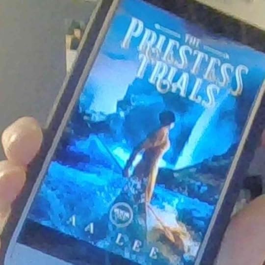 The Priestess Trials cover on a cell phone