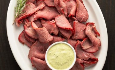 Sliced, smoked venison backstrap on a platter.